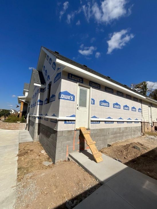 A house is being built with a lot of insulation on the side of it.