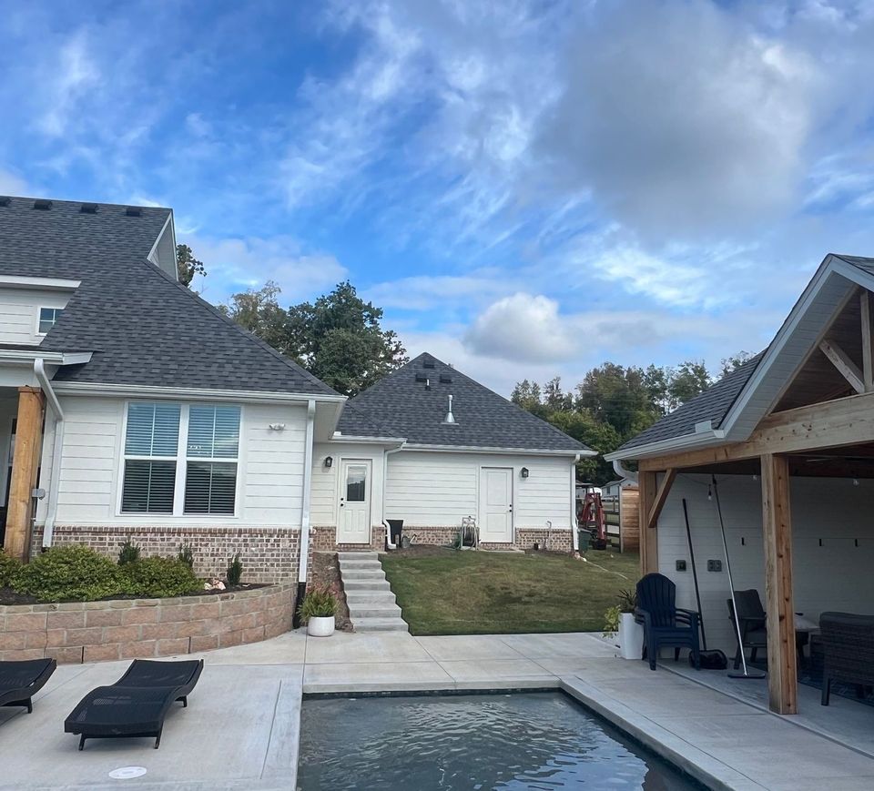 A house with a swimming pool in front of it