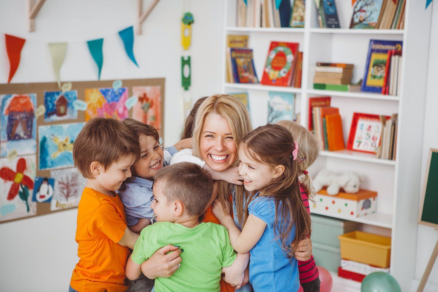 Children Hugging their Teacher — Woodridge, IL — Montessori of Woodridge