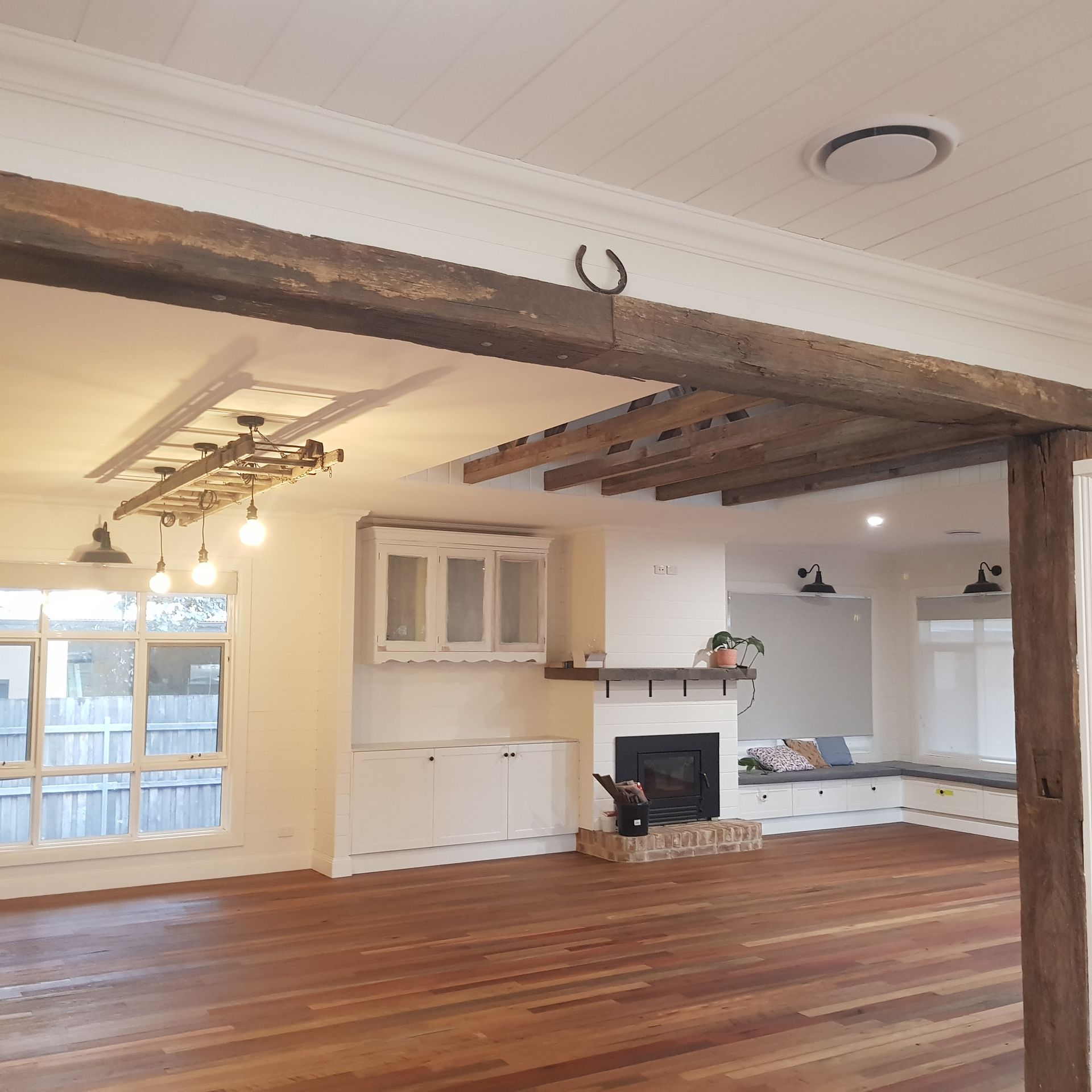 A living room with a fireplace and wooden floors