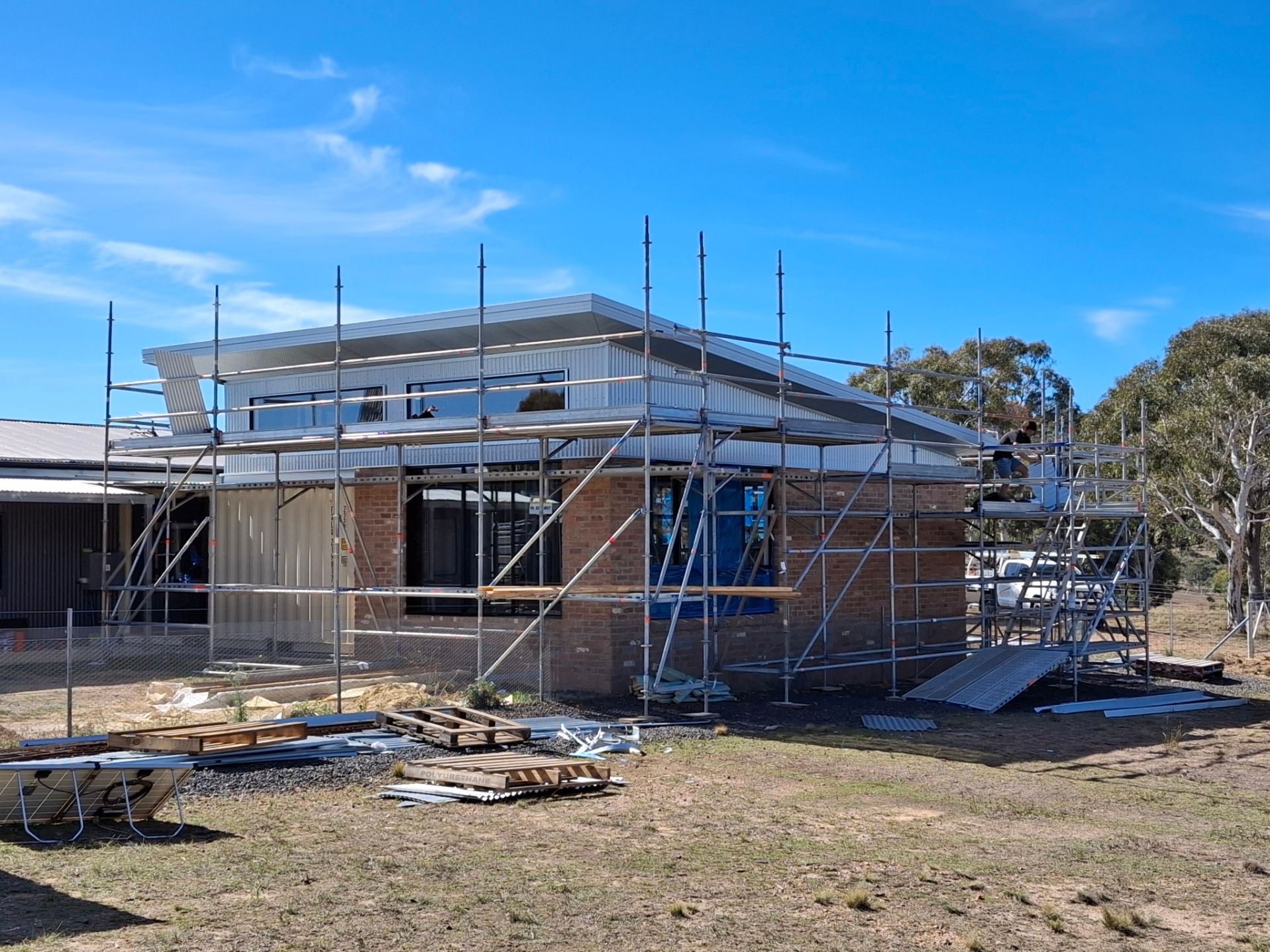 A house is being built with scaffolding around it.