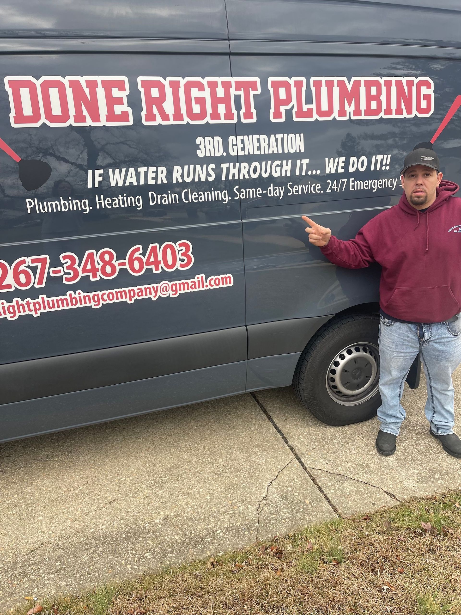 A man is standing in front of a van that says done right plumbing.