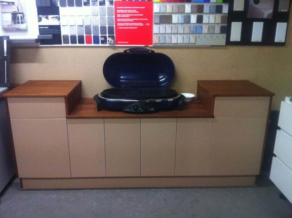 A Grill Is Sitting On Top Of A Counter In A Kitchen — Standfast Cabinets In Tuggerah, NSW