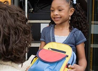 Mother Handing Daughter Backpack — Child Development Centers  in Detroit, MI