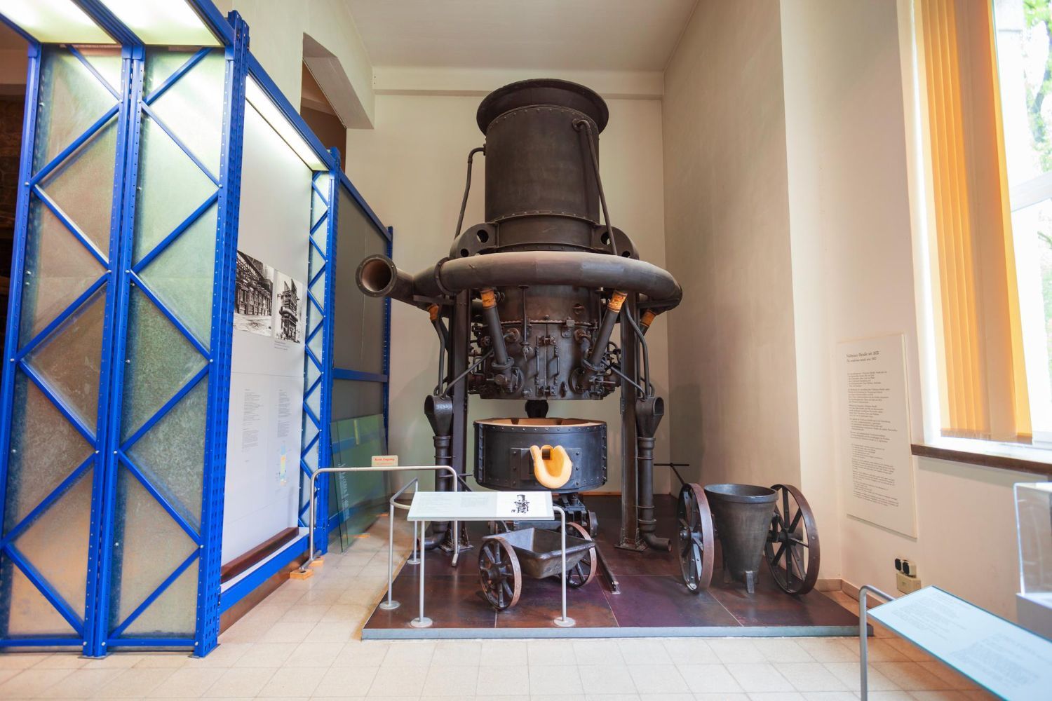 A large machine is sitting in a room next to a window.