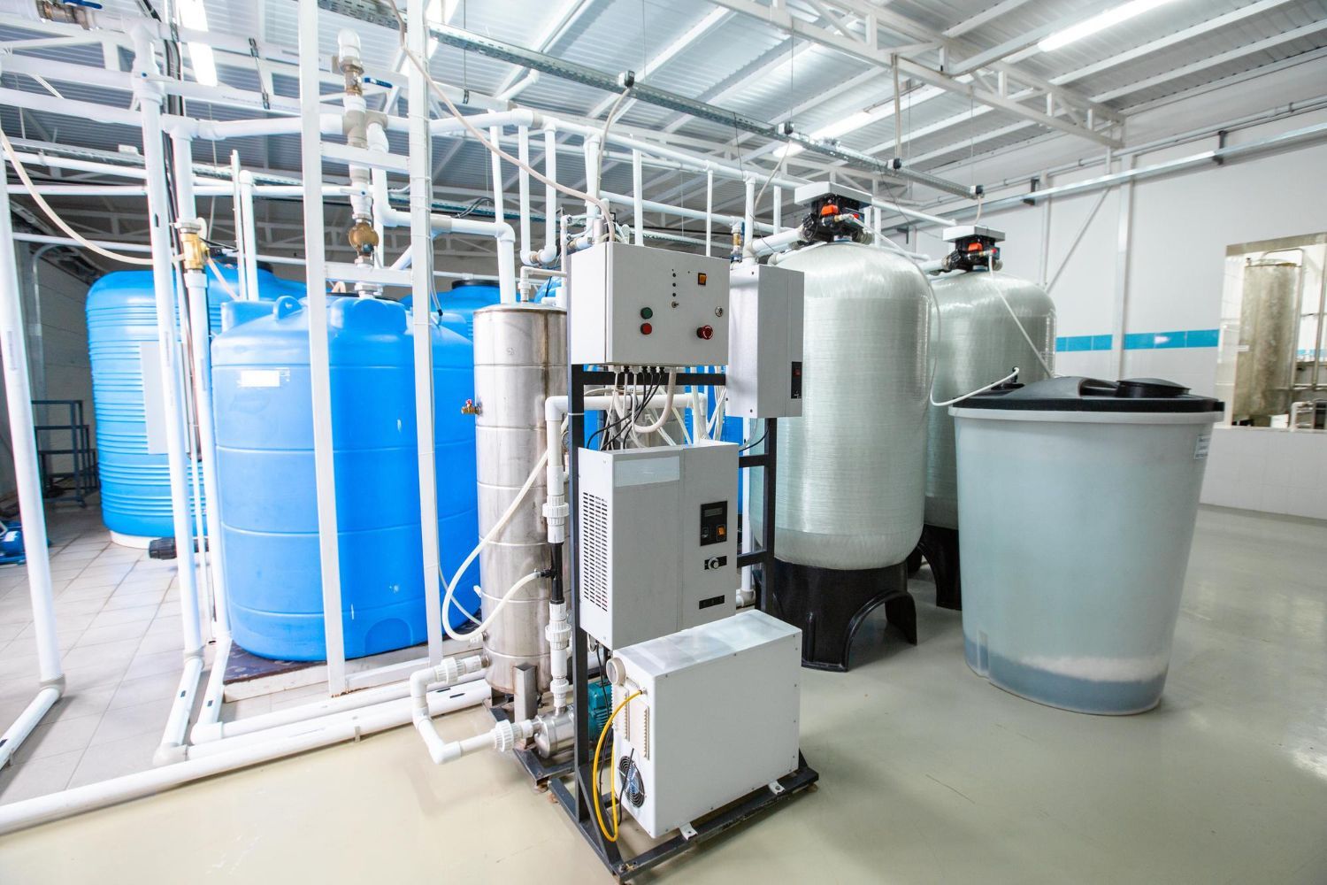 A warehouse filled with lots of water tanks and machinery.