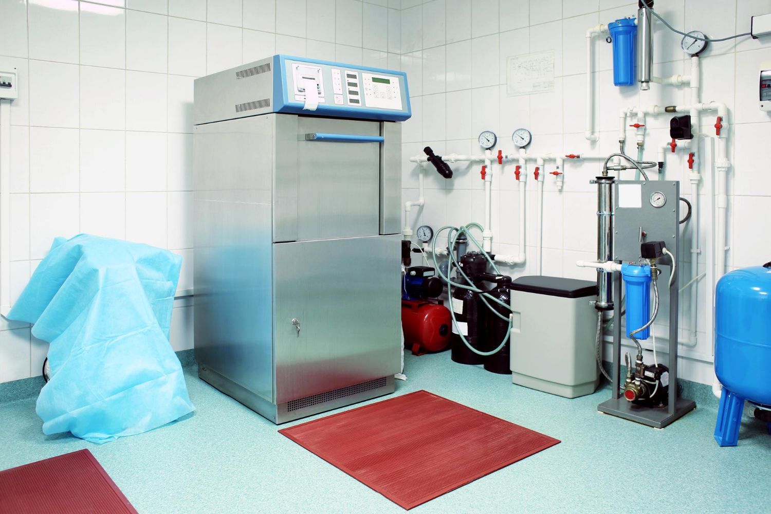 A large stainless steel machine from Boiler Technologies Unlimited sits in a room.