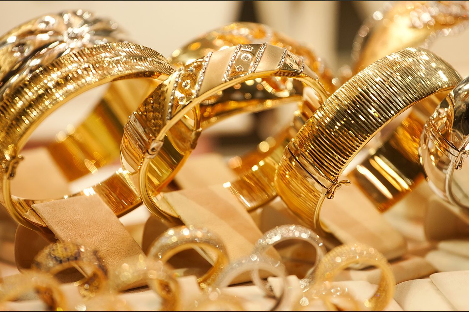 Gold bracelets and rings on display. Gold bracelets and rings on display.