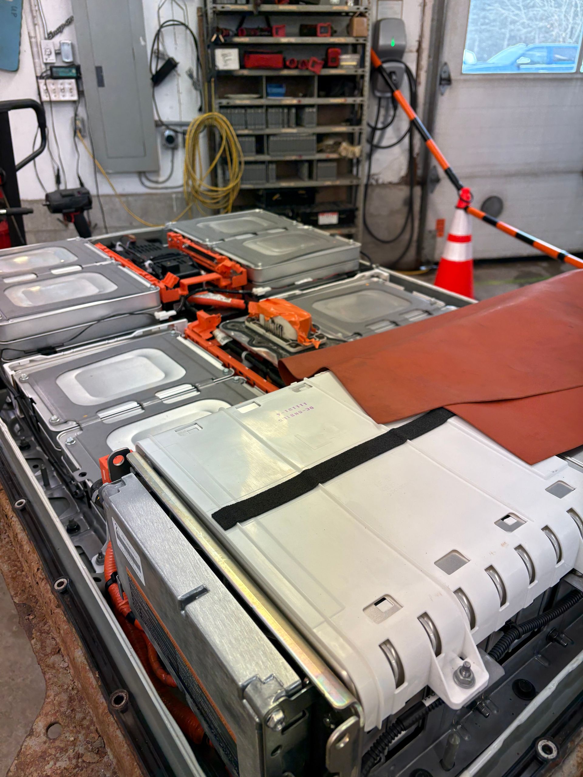 A bunch of batteries are sitting on a table in a garage