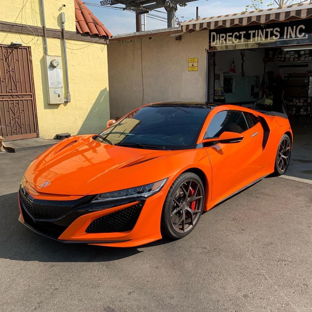 Black RAM TRX truck parked in front of a building with a billboard.
