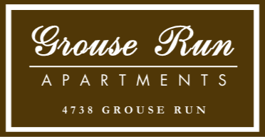 Grouse Run Apartments sign on brown background with white border and text, “4738 Grouse Run”