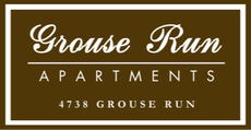 Grouse Run Apartments sign on brown background with white border and text, “4738 Grouse Run”