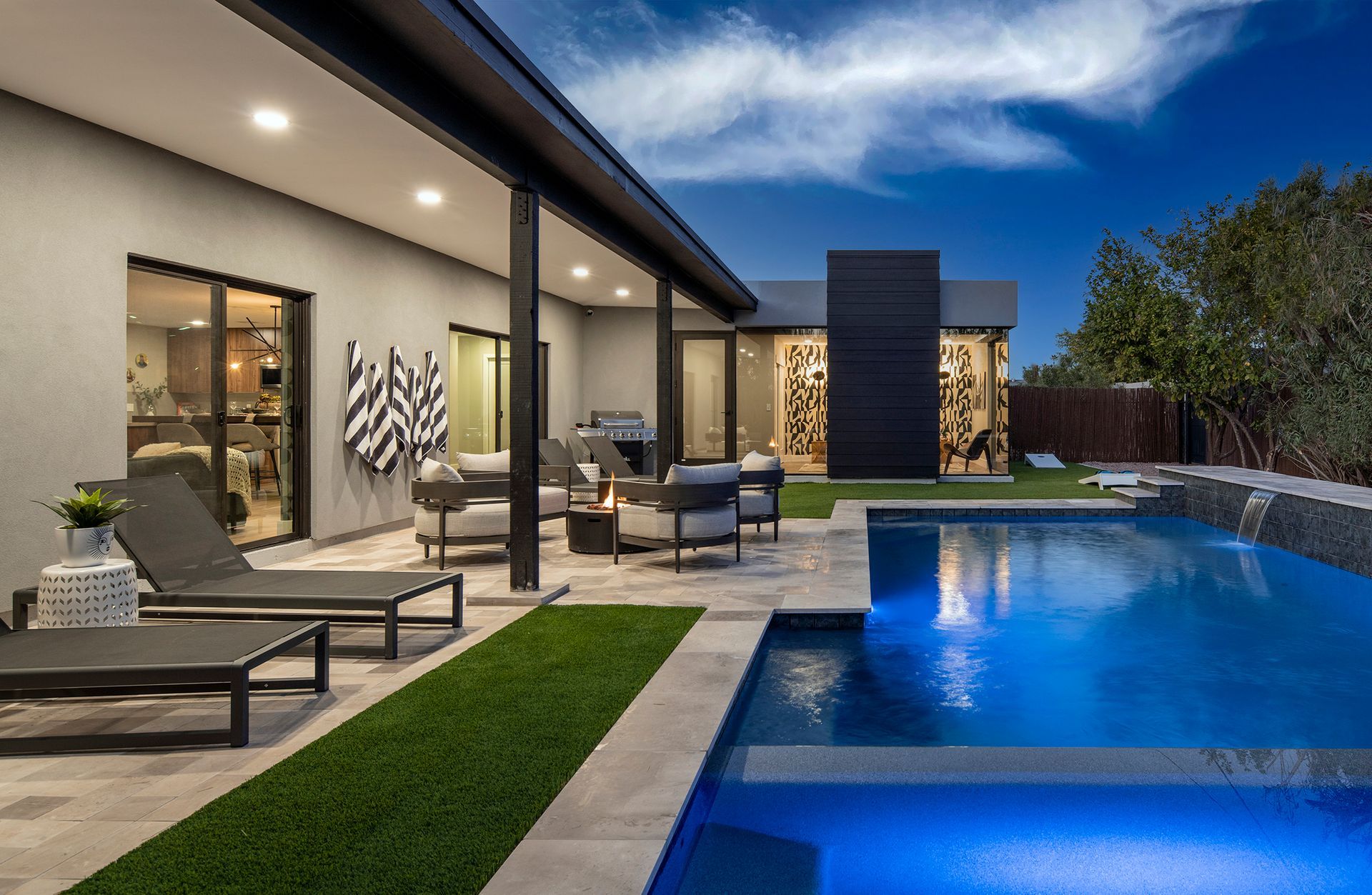a large swimming pool is in the backyard of a house .