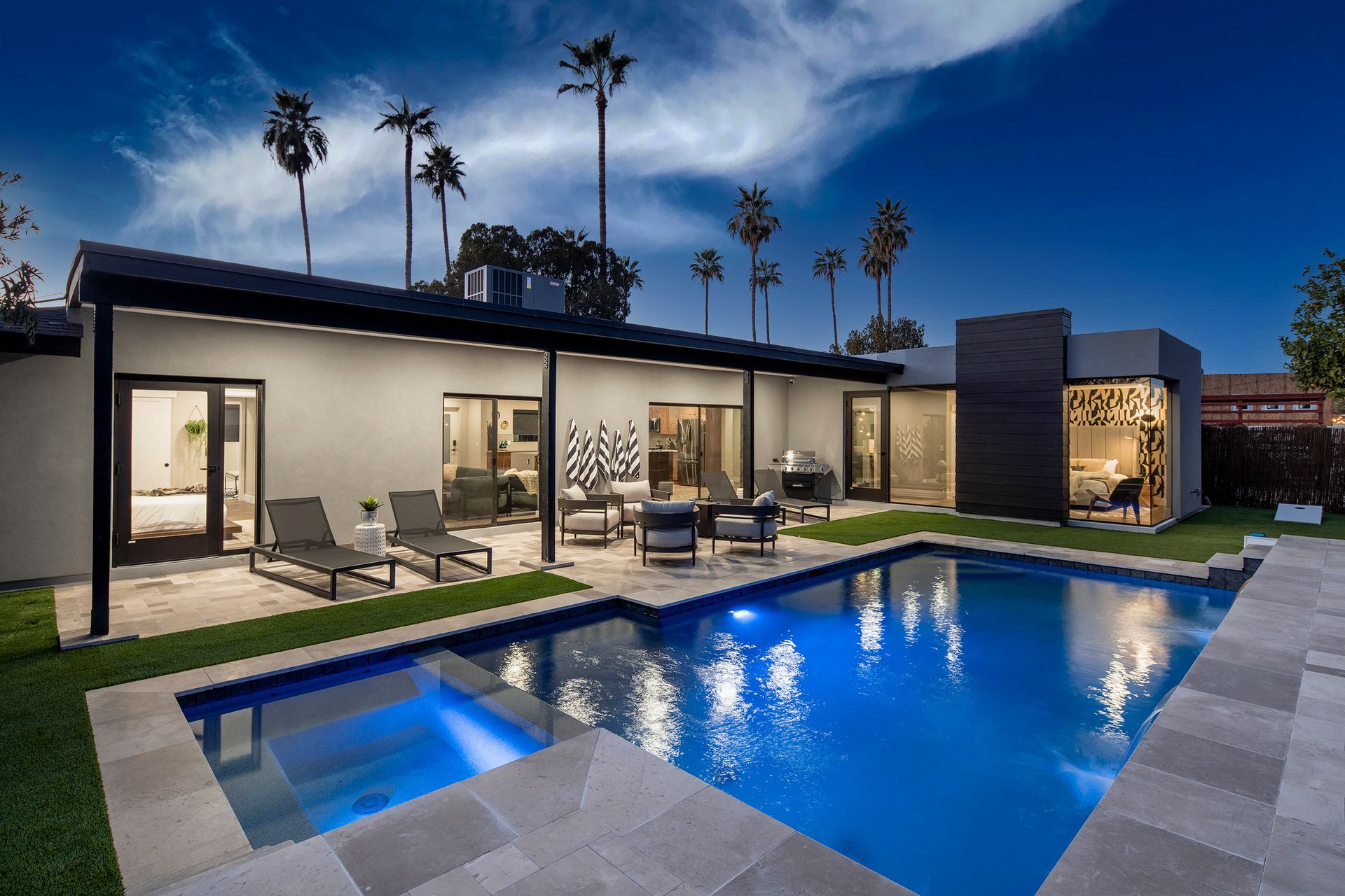 a house with a large swimming pool in front of it