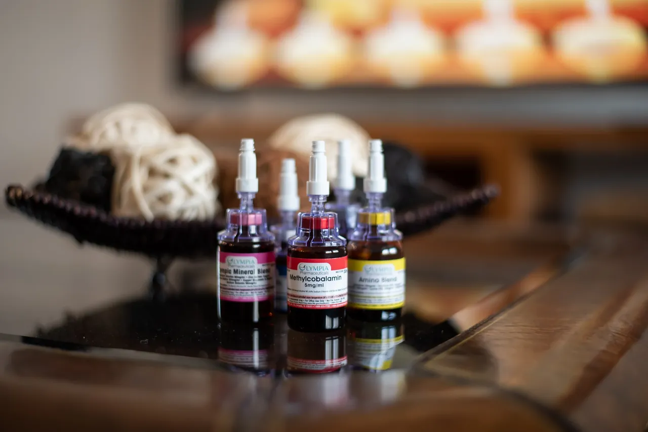 Three bottles of IVs are sitting on a glass table.