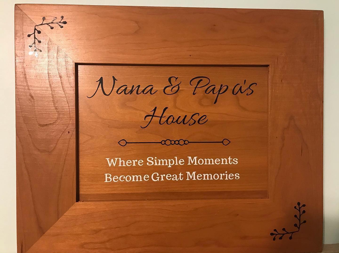 a wooden picture frame with nana and papa 's house written on it