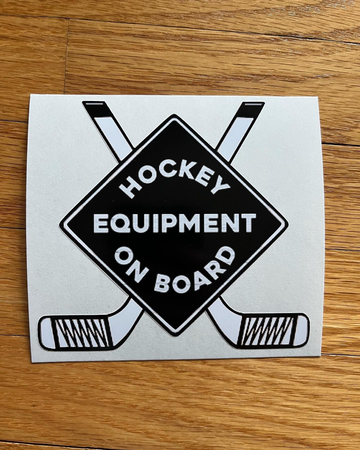 a sticker that says hockey equipment on board