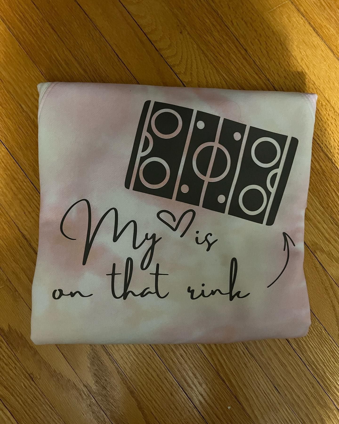 a tie dye shirt that says my heart is on that rink