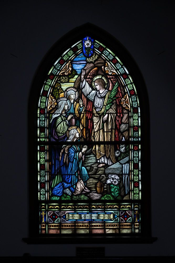 A stained glass window in a church depicting a nativity scene