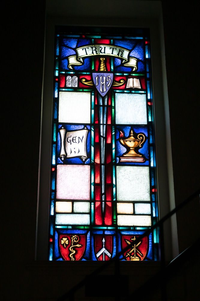 A stained glass window with the word trust on it