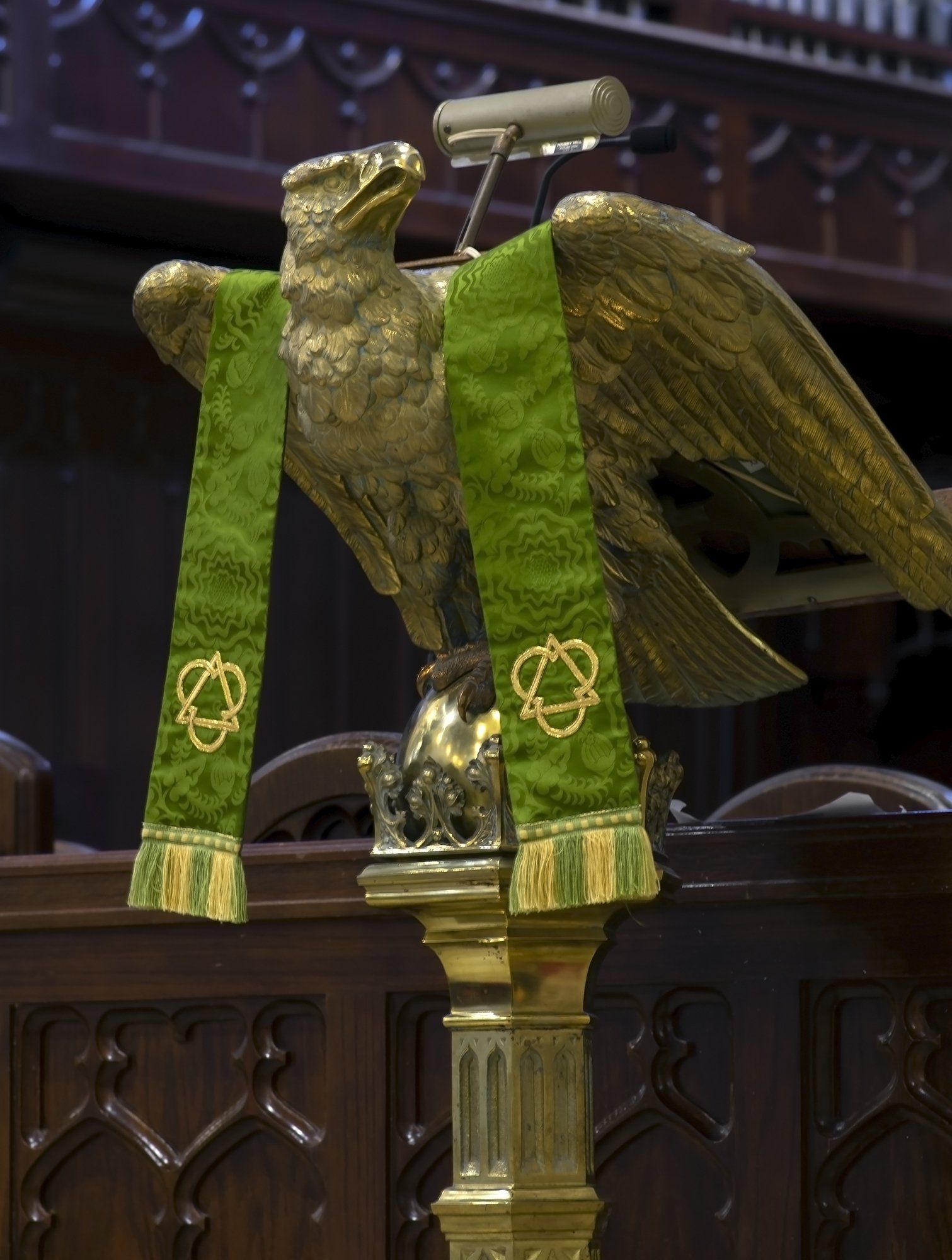 A statue of an eagle with a green stole around its neck