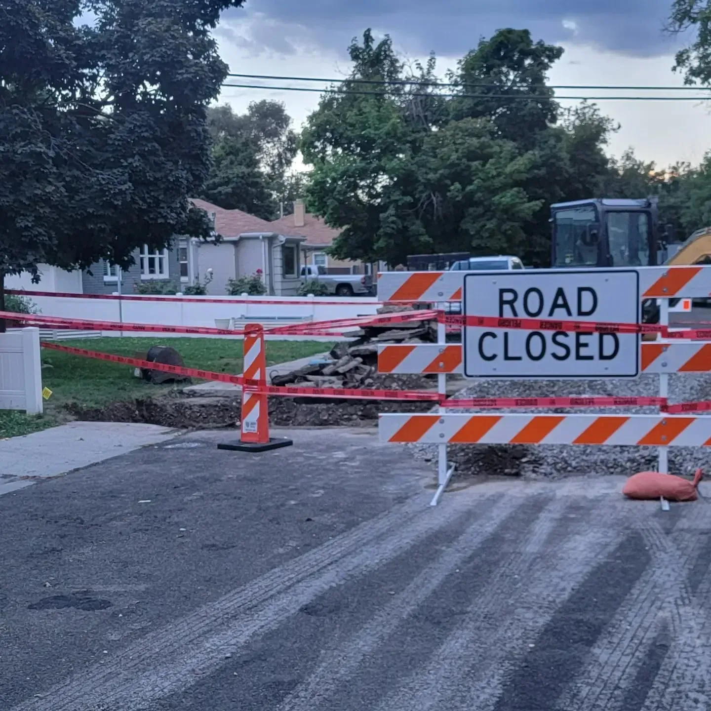 A construction site on a residential street with a 