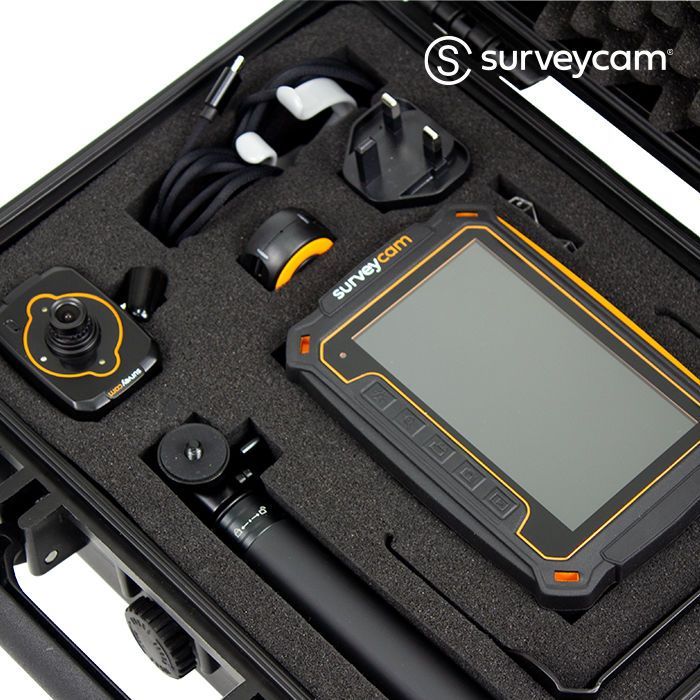 Black case containing a survey camera system with monitor, camera head, power adapter, and accessories.