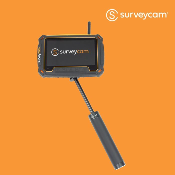 Surveycam handheld device with orange and black casing, attached to a telescoping pole, orange background.