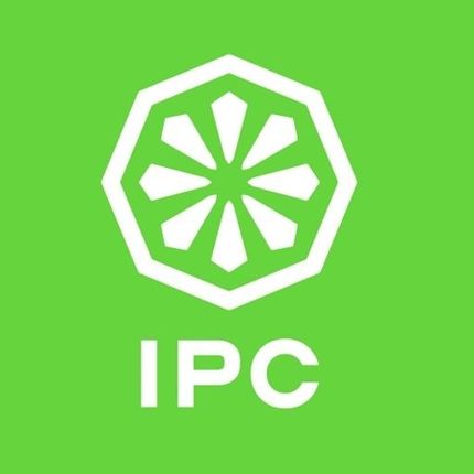 White IPC logo on a green background. The logo is a segmented wheel inside a white octagonal shape. "IPC" appears below.