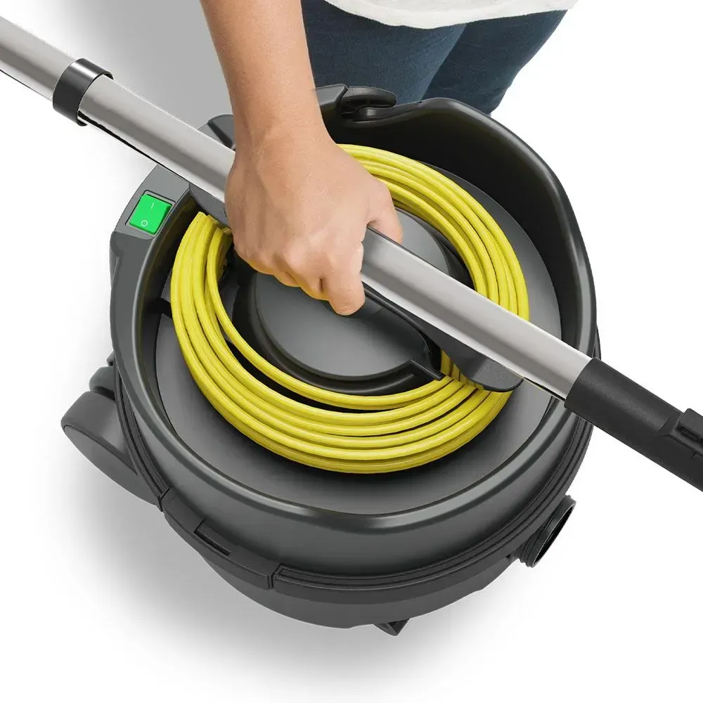 Black Numatic vacuum cleaner with yellow cord, hose, and cleaning head.