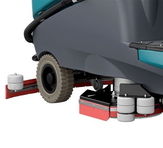 Turquoise and gray industrial floor sweeper with a steering wheel and flashing light.