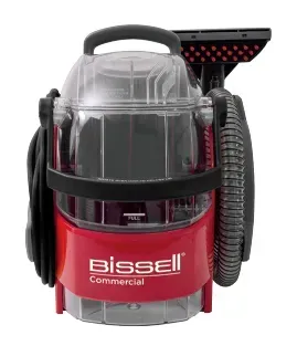 Red and clear Bissell commercial carpet cleaner with hose, nozzle, and handle.