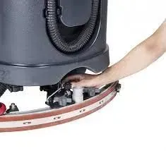 Black and red ride-on floor scrubber with a steering wheel and seat.