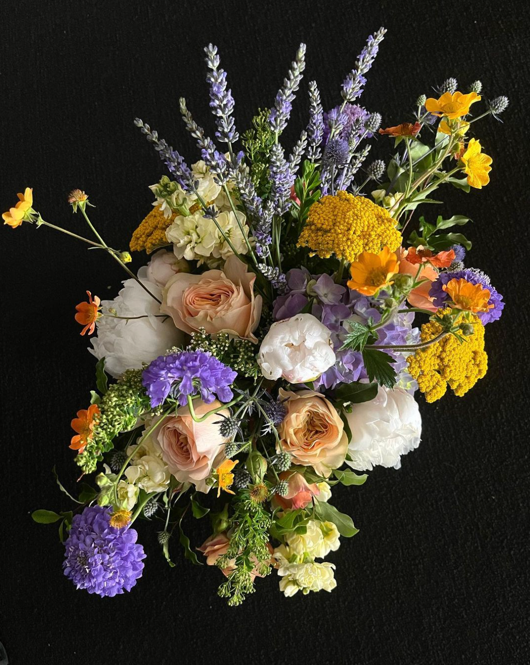 A bouquet of colorful flowers on a black background