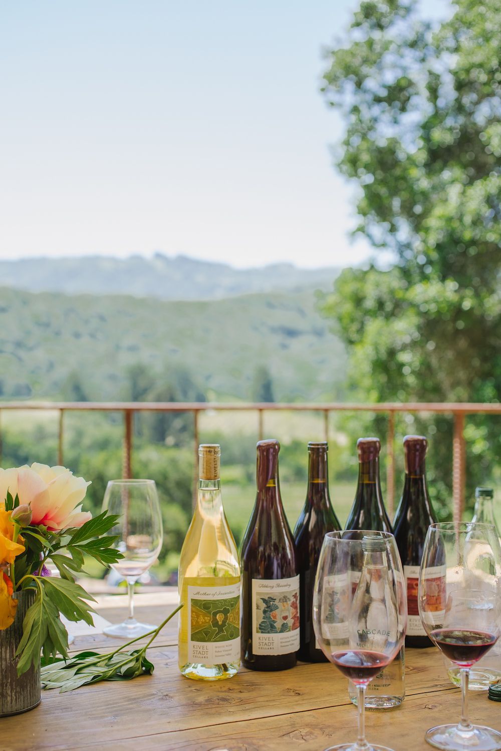 A table with bottles of wine and glasses on it.