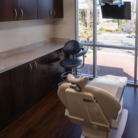 a dental office with a dental chair and a large window