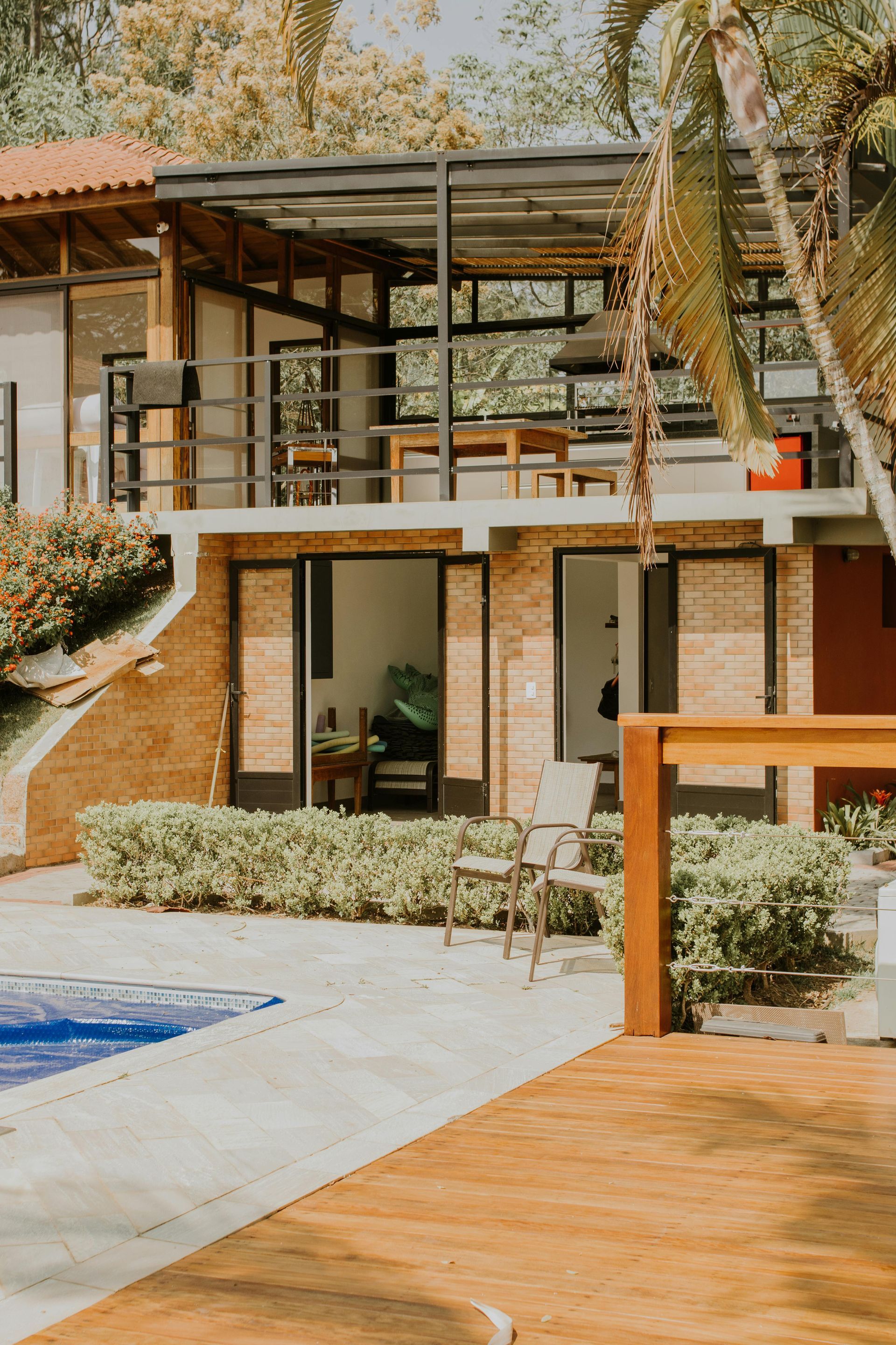 A large house with a swimming pool in front of it