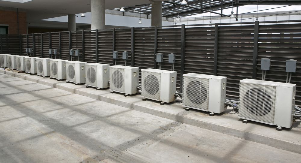 Row of White Outdoor Air Conditioning Units — Alpine Refrigeration & Air Conditioning Pty Ltd in Wollongong, NSW