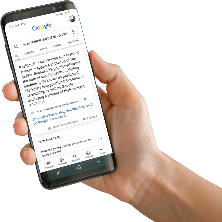 a hand holding smartphone showing how Search Engine Optimization in Denver CO help obtain position zero