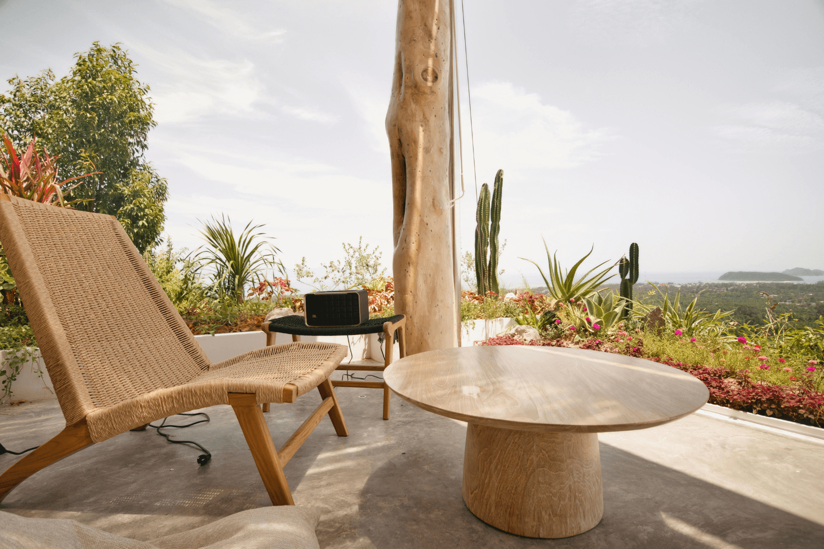 Workers leveling wet concrete with a bull float to create a sidewalk. One wears a neon vest and jeans.