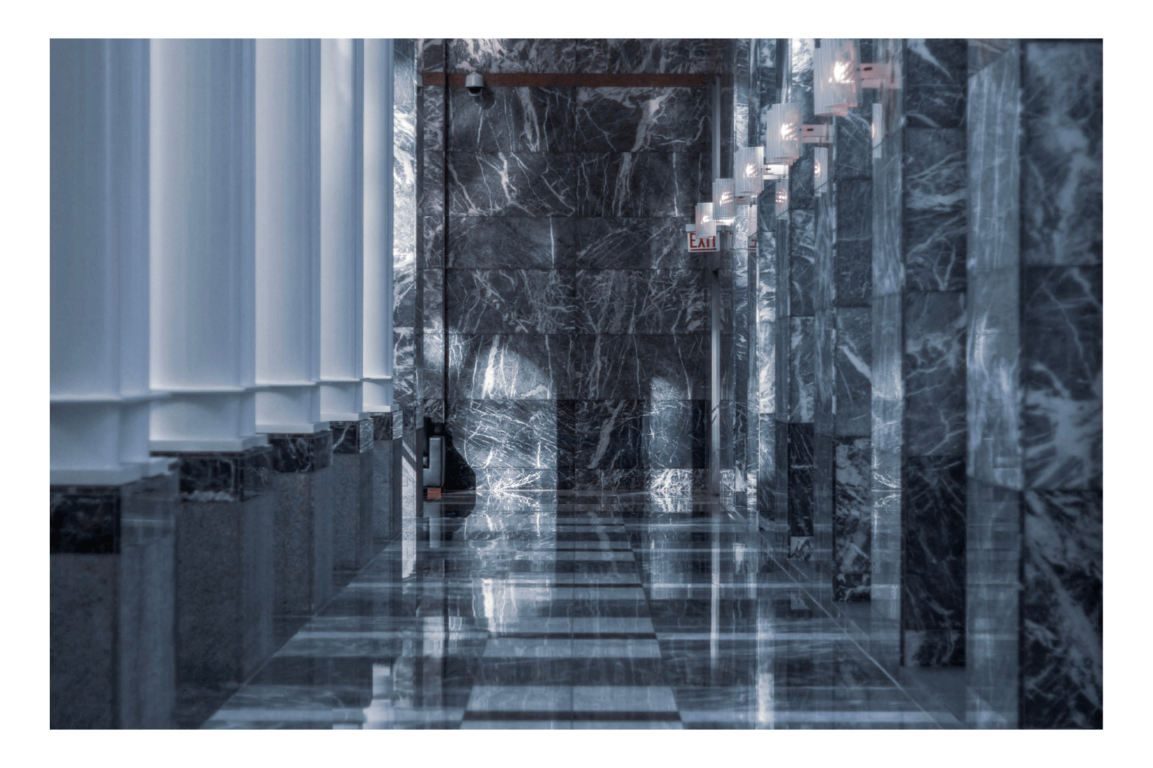 Workers leveling wet concrete with a bull float to create a sidewalk. One wears a neon vest and jeans.