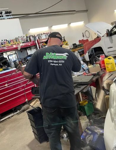 A man is working on a car in a garage.