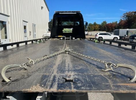 A tow truck is parked in front of a building.