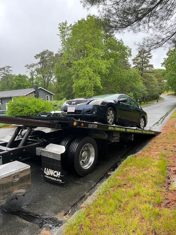 A car is sitting on top of a tow truck.