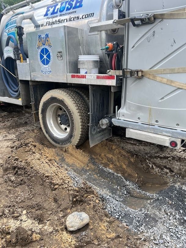 A vacuum truck is digging a hole in the ground.