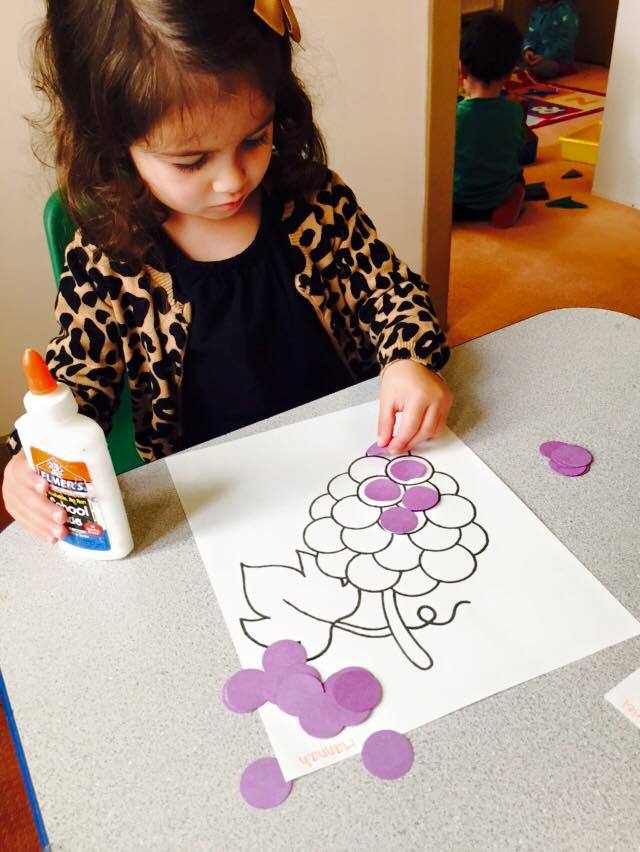 Child Gluing Paper Crafts, Preschool Center in Marin CA