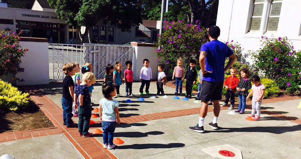 kids learning a game outside with adult