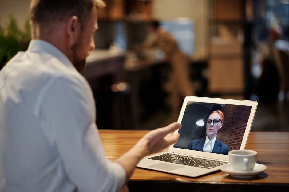 Professional using a laptop for virtual arbitration services without an in-person hearing