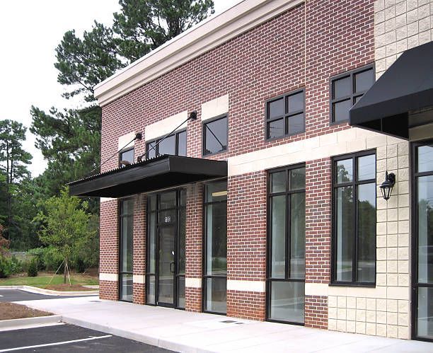 Bright dining room with white furniture, large glass doors overlooking a backyard.