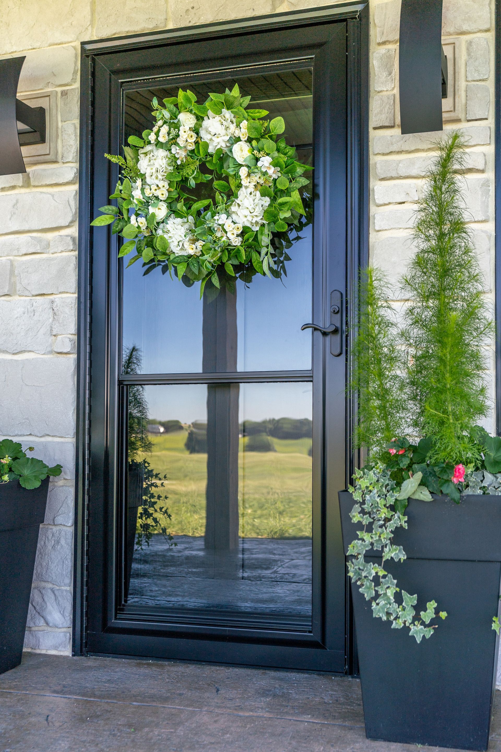 White window with handle open, framed against a bright blue sky.